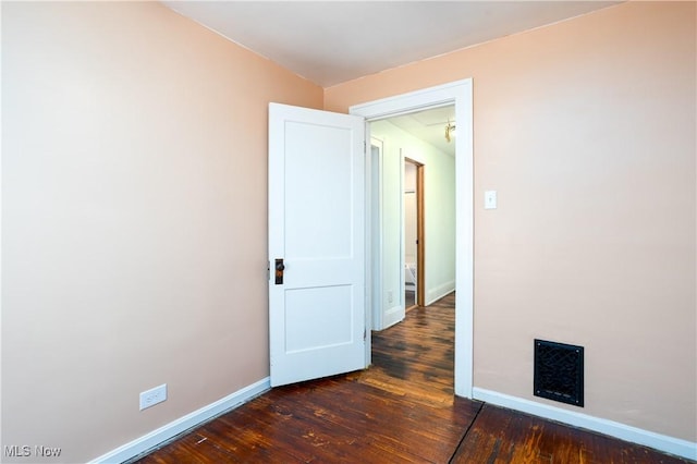 unfurnished room with dark hardwood / wood-style flooring