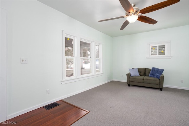 sitting room featuring ceiling fan and carpet floors