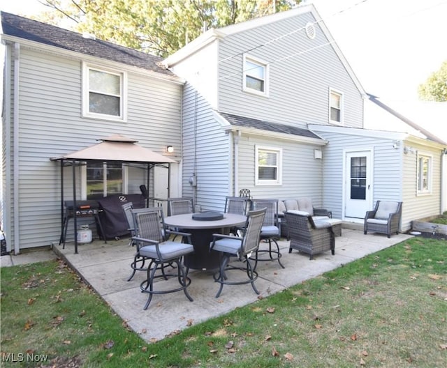 back of property with a gazebo, a patio, a yard, and outdoor lounge area