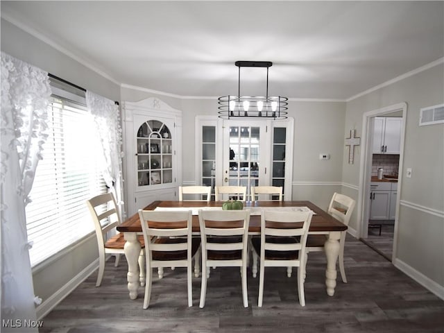 dining room with a chandelier, plenty of natural light, ornamental molding, and dark hardwood / wood-style floors