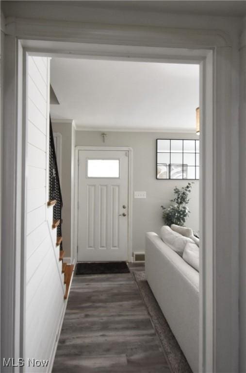 entryway featuring crown molding and dark hardwood / wood-style floors