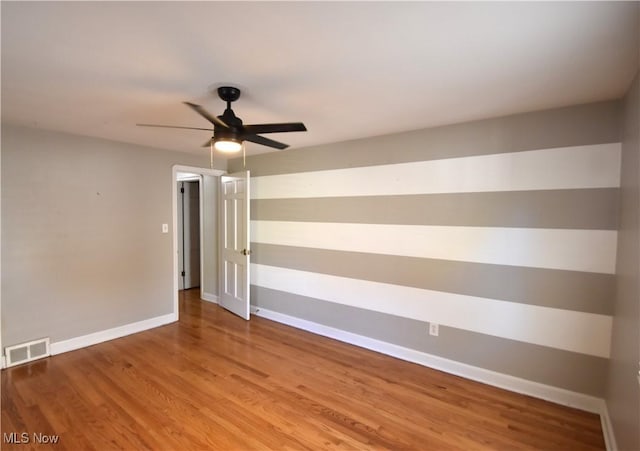 spare room featuring hardwood / wood-style flooring and ceiling fan