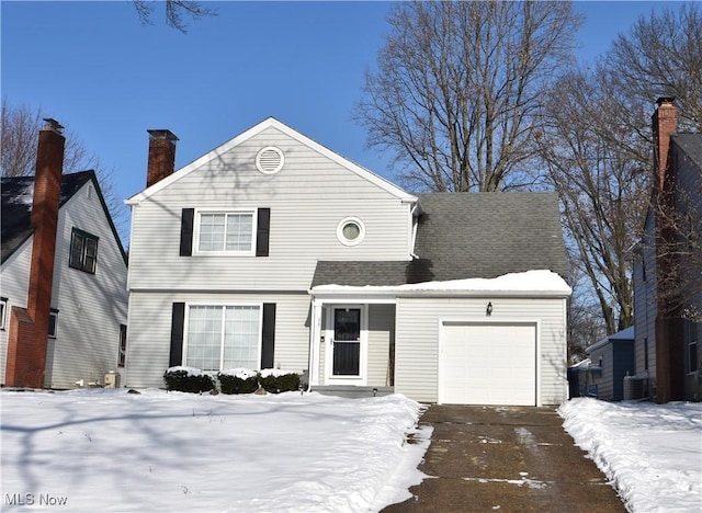 view of front of house featuring central AC unit and a garage