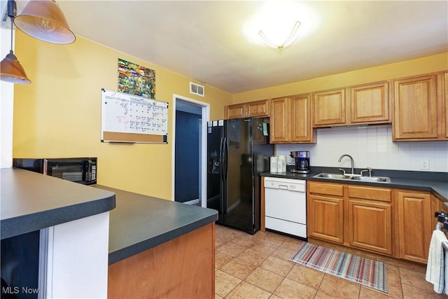 kitchen with sink, backsplash, white dishwasher, black fridge with ice dispenser, and light tile patterned floors