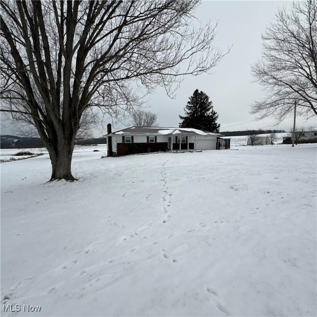 view of yard layered in snow