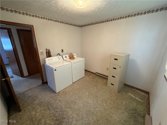 clothes washing area with baseboard heating, washer and clothes dryer, light colored carpet, and a textured ceiling