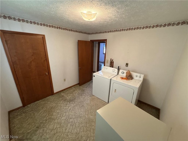 laundry area featuring a textured ceiling and separate washer and dryer