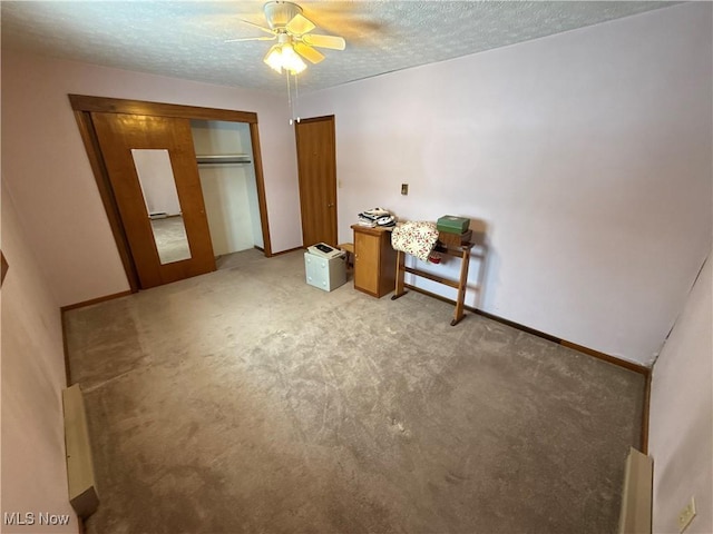 carpeted bedroom with a textured ceiling, a closet, and ceiling fan