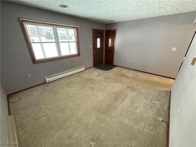 interior space with light carpet, a textured ceiling, and a baseboard heating unit