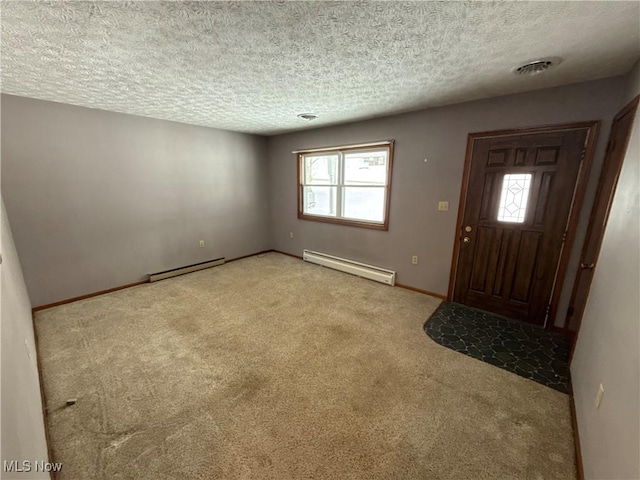 carpeted foyer entrance featuring a textured ceiling and a baseboard heating unit