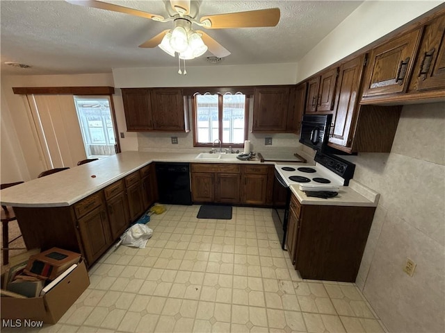 kitchen featuring ceiling fan, sink, kitchen peninsula, a textured ceiling, and black appliances