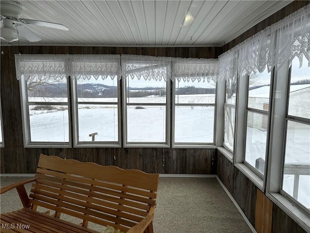 sunroom featuring ceiling fan