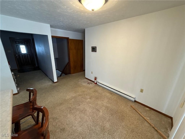 unfurnished room featuring carpet floors, a baseboard radiator, and a textured ceiling