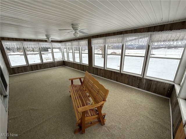 unfurnished sunroom with ceiling fan