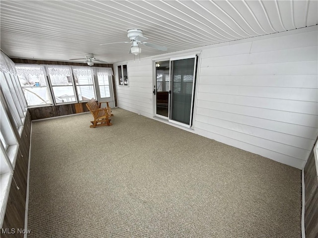 unfurnished sunroom featuring ceiling fan