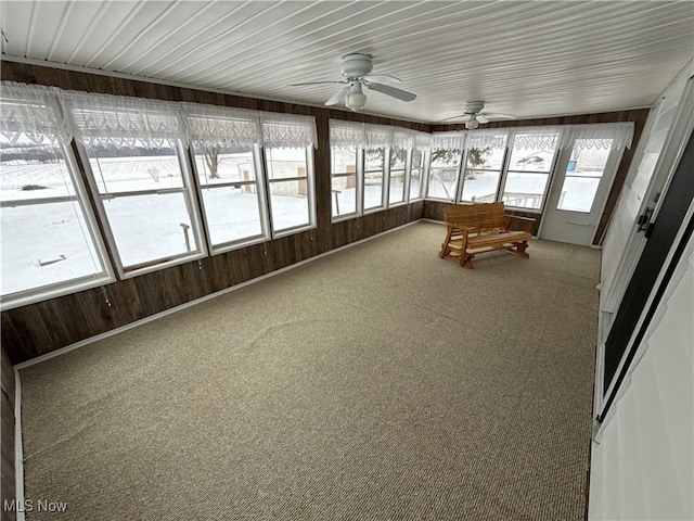 unfurnished sunroom with ceiling fan