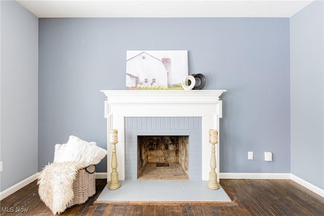 interior details with hardwood / wood-style flooring and a brick fireplace