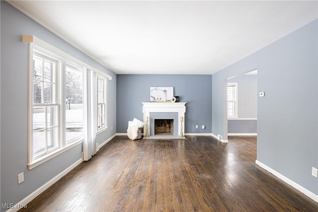 unfurnished living room with dark hardwood / wood-style flooring and a fireplace