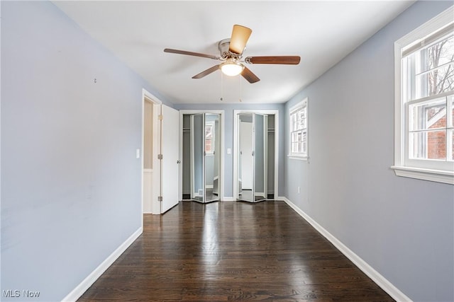 spare room featuring dark hardwood / wood-style flooring and ceiling fan