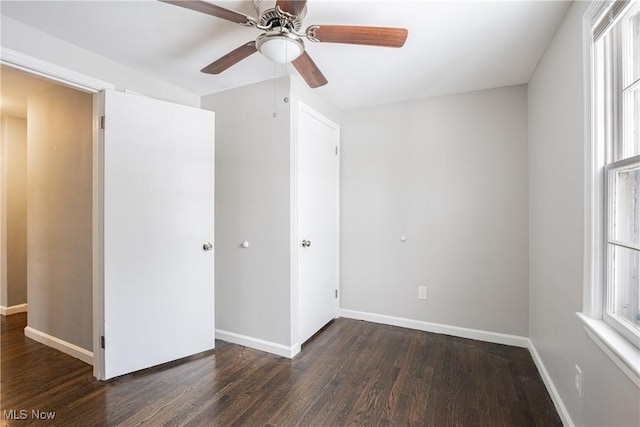 unfurnished bedroom featuring ceiling fan and dark wood-type flooring