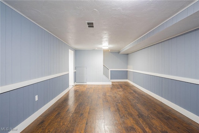 basement with dark hardwood / wood-style floors