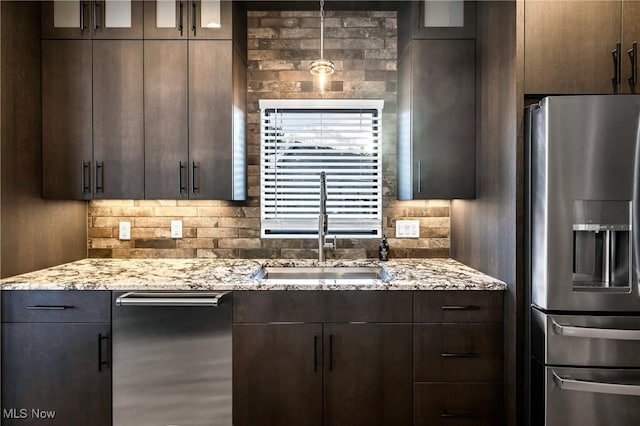 kitchen with stainless steel fridge with ice dispenser, dark brown cabinets, and sink