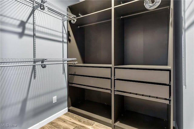 walk in closet featuring hardwood / wood-style floors