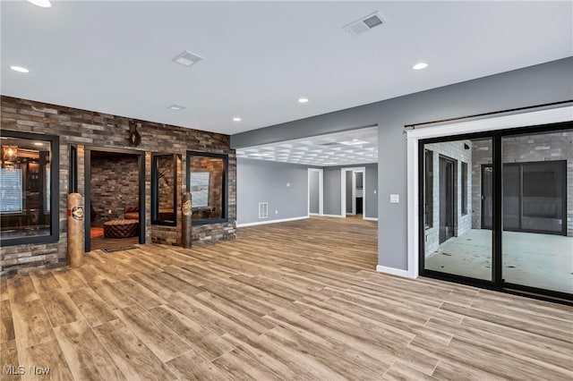 unfurnished living room with light hardwood / wood-style flooring