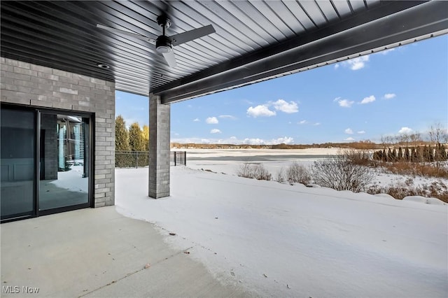 snow covered patio featuring ceiling fan