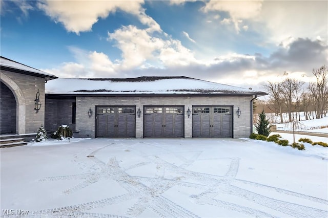 view of snow covered garage