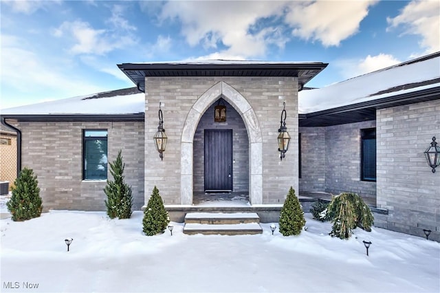 view of snow covered property entrance