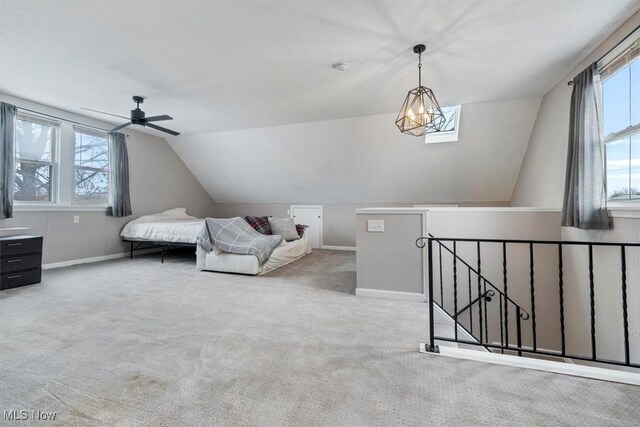 interior space with ceiling fan with notable chandelier and vaulted ceiling