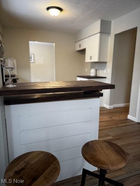 kitchen with white cabinets and dark hardwood / wood-style floors