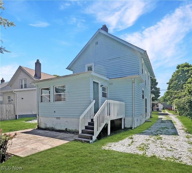 rear view of house with a yard