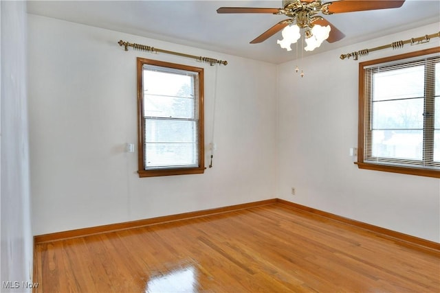 empty room featuring wood-type flooring and ceiling fan