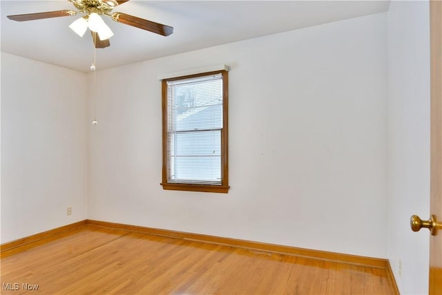 empty room with hardwood / wood-style floors and ceiling fan