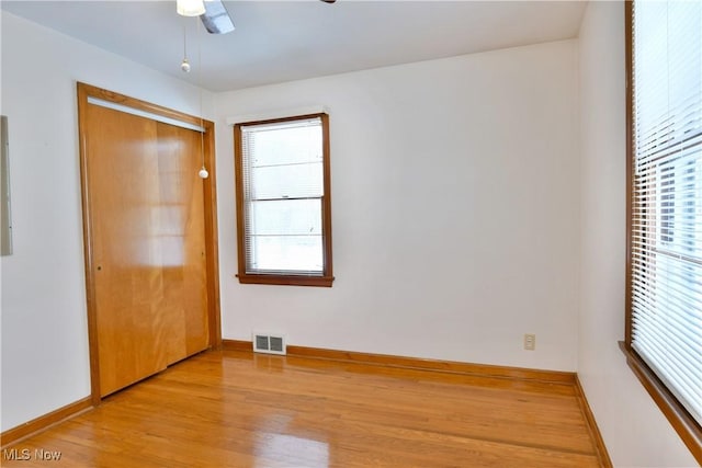 unfurnished bedroom featuring ceiling fan, a closet, and light hardwood / wood-style flooring