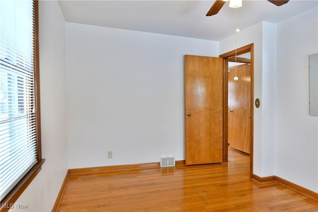 empty room featuring ceiling fan and light wood-type flooring