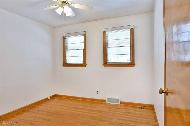 unfurnished room featuring a wealth of natural light, light hardwood / wood-style flooring, and ceiling fan