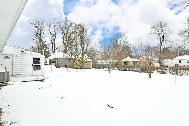 yard covered in snow with cooling unit