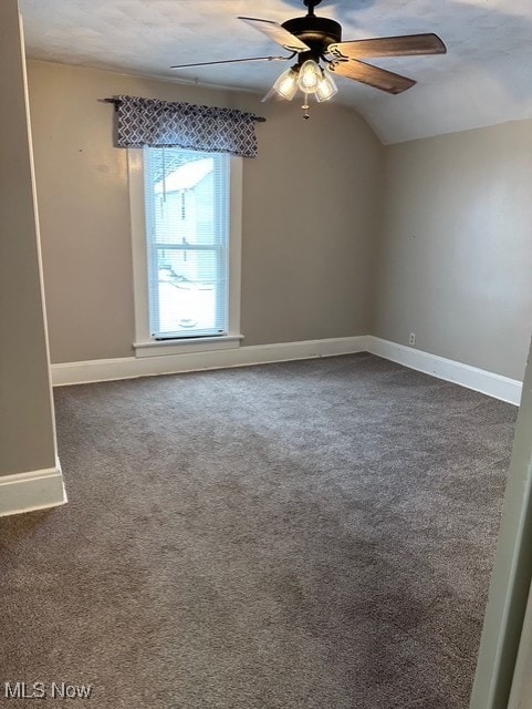 carpeted empty room with ceiling fan and lofted ceiling