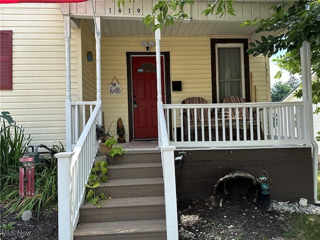 doorway to property featuring covered porch