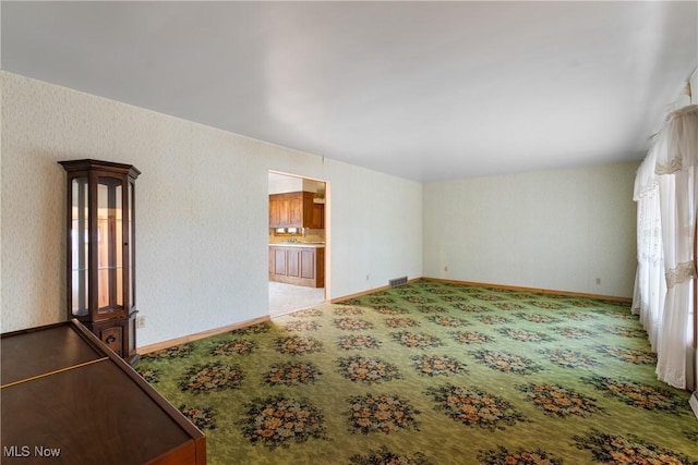 unfurnished living room featuring light colored carpet