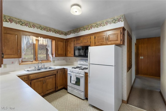 kitchen with tasteful backsplash, sink, and white appliances