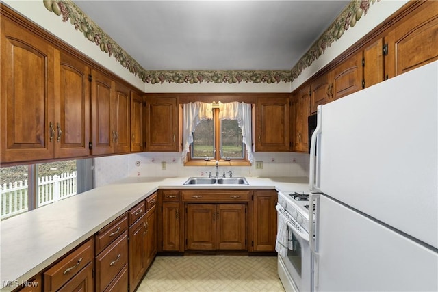 kitchen with sink and white appliances