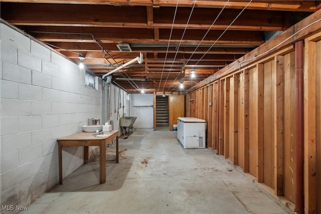 basement with refrigerator and sink