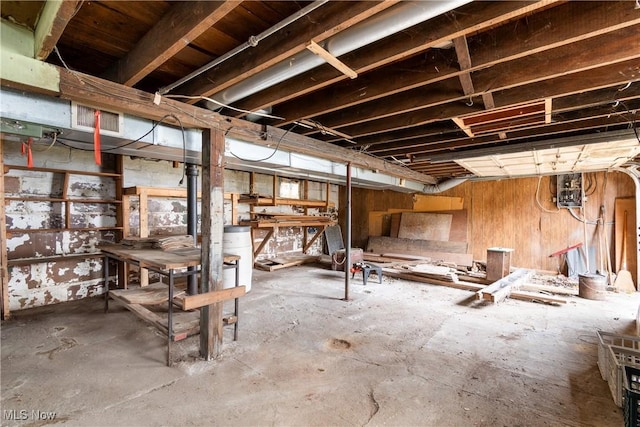 miscellaneous room featuring a workshop area and concrete floors