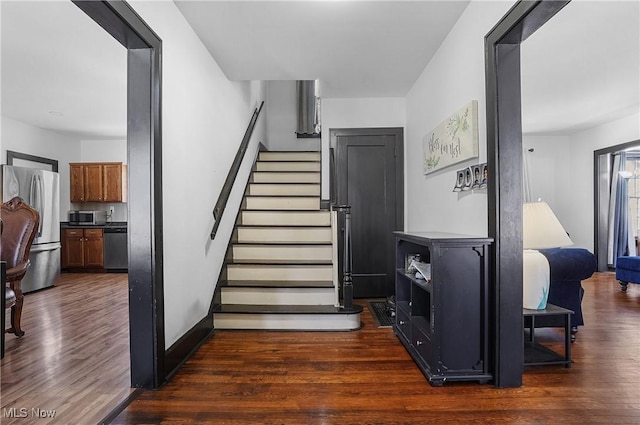 stairs with hardwood / wood-style floors