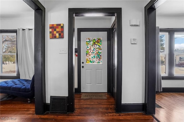 foyer entrance with dark hardwood / wood-style floors