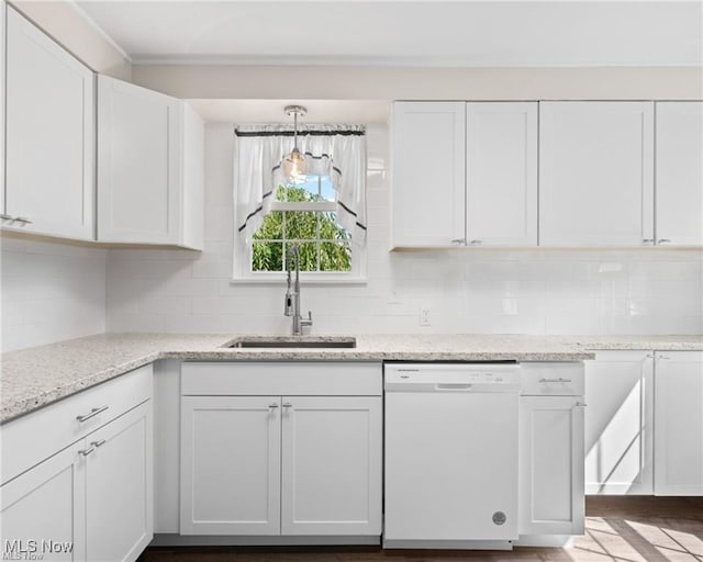 kitchen featuring decorative backsplash, light stone countertops, white cabinets, sink, and dishwasher